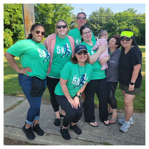 SECU employees smiling outside