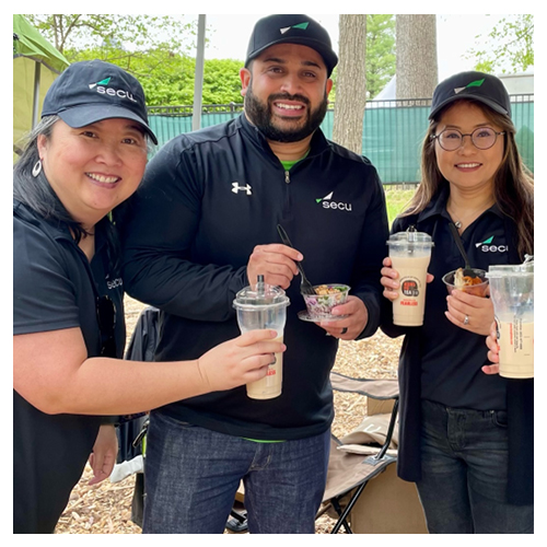 SECU employees smiling and eating dessert