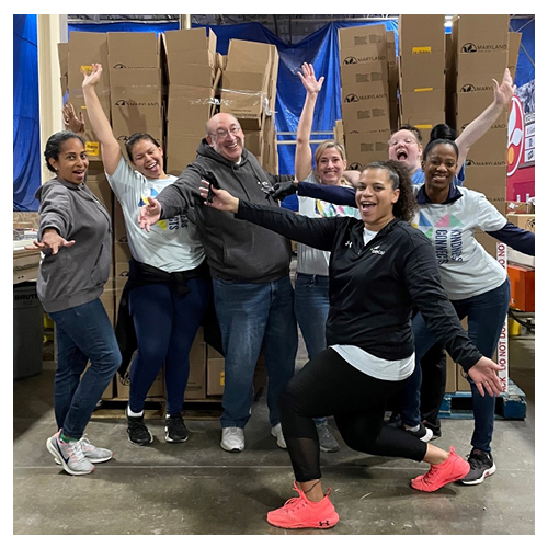 SECU employees in a warehouse smiling