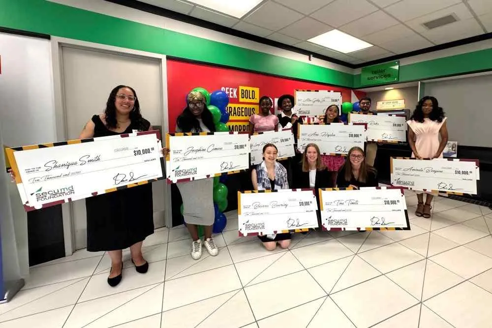 2025 SECU MD Foundation scholarship winners pose with their large checks