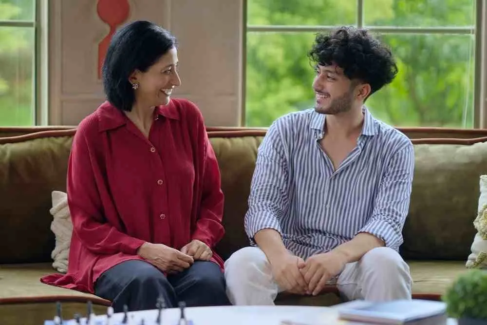 Mother and son sit on couch taking to each other