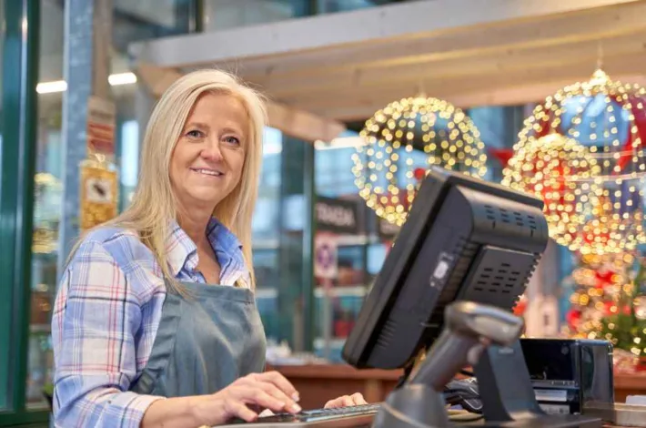 Senior woman working in a plant nursery during Christmas season