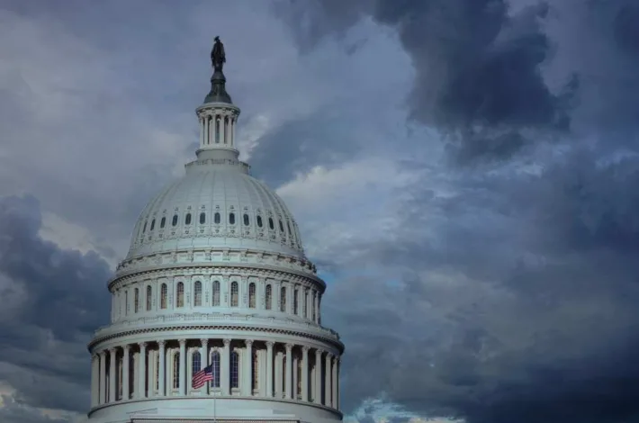 Close up of the US capitol building dome with gathering storm clouds