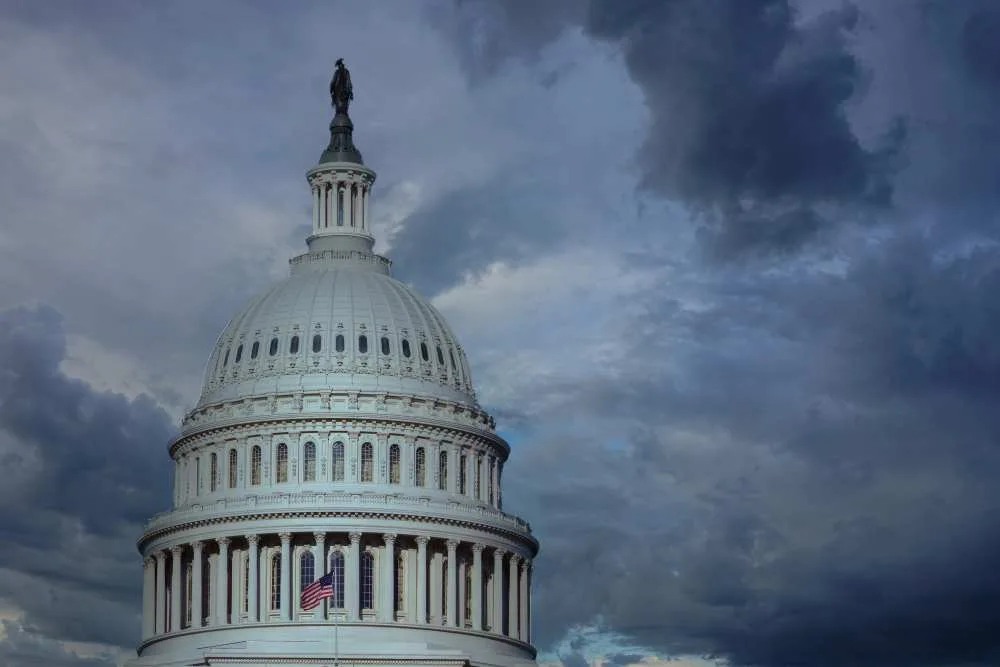 Close up of the US capitol building dome with gathering storm clouds
