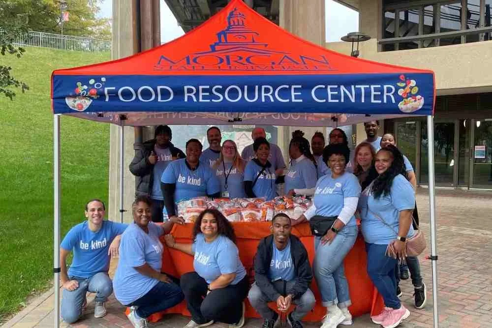Team of people posing for group photo under a Morgan State Food Resource Center tent