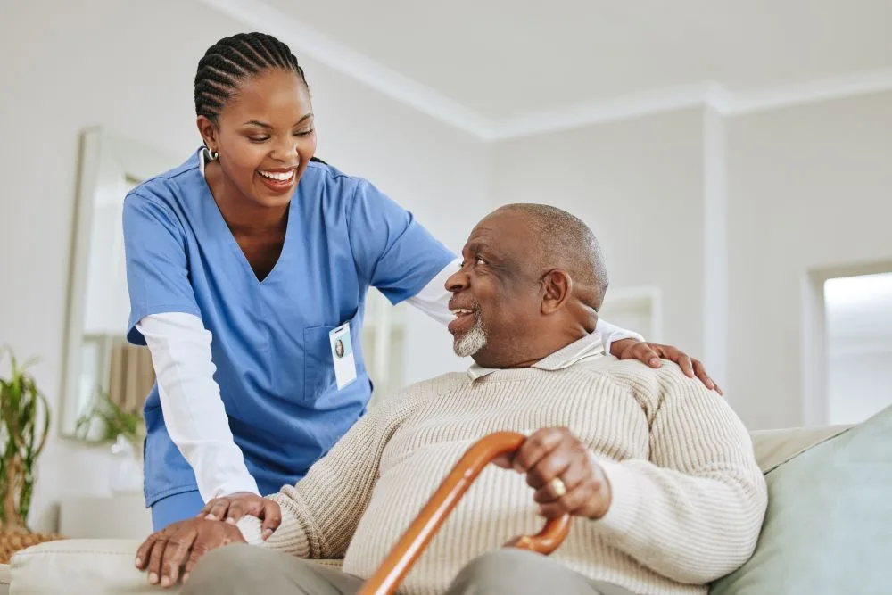 Woman nurse smiles looking after male patient