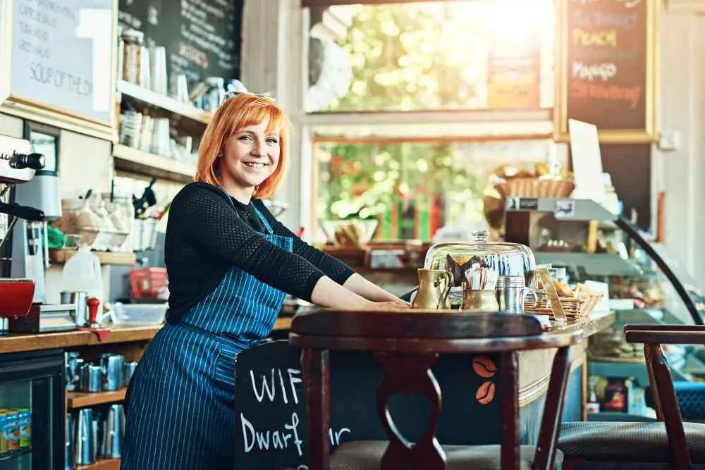 Woman standing at coffee shop checkout counter