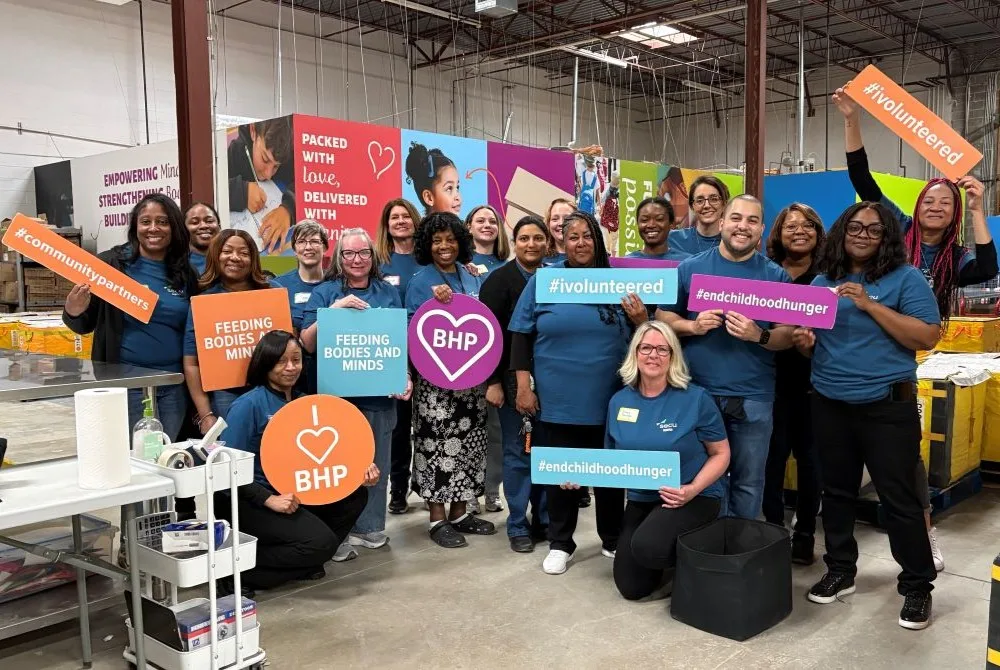 Group of people holding signs at a volunteer event