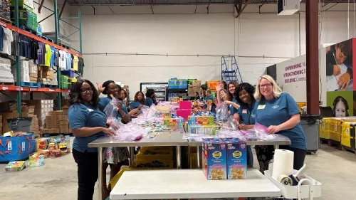 Group of volunteers packing snacks into bags
