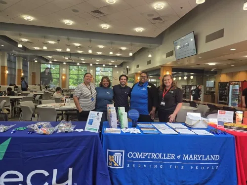 SECU volunteers standing behind table at Frederick Community College
