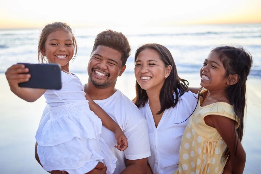Family taking selfie at the beach