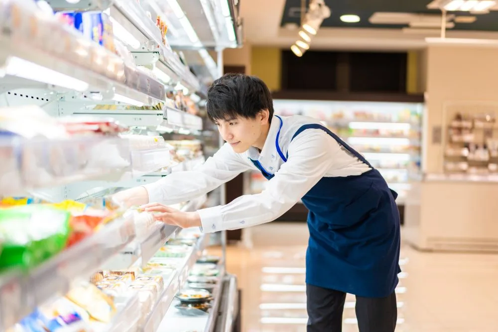 Male teen staffer working at a supermarket