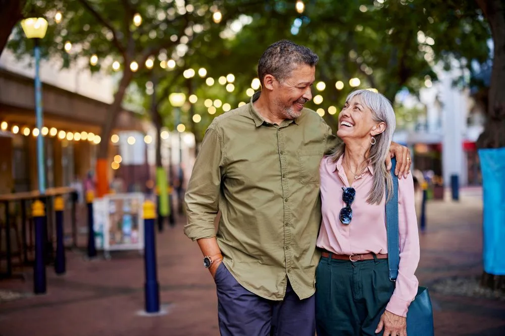 Retirement-age couple looks happy walking down sidewalk